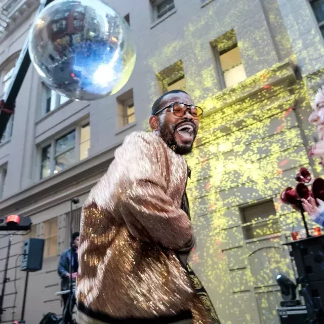 Dancer dancing under a giant disco ball in San Francisco
